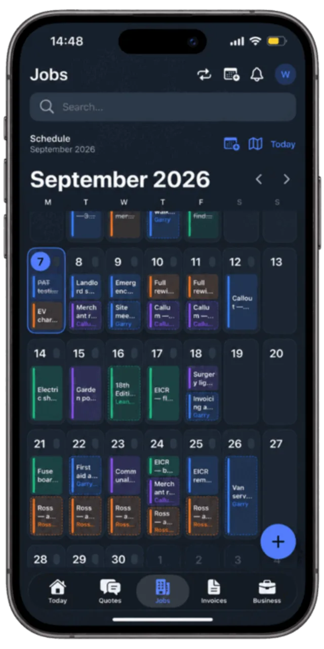 A month view of the Traddie calendar on a phone showing jobs, meetings, merchant runs, training and multi-day holidays colour coded by person
